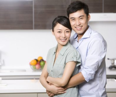 Portrait of Chinese couple arm around in the kitchen