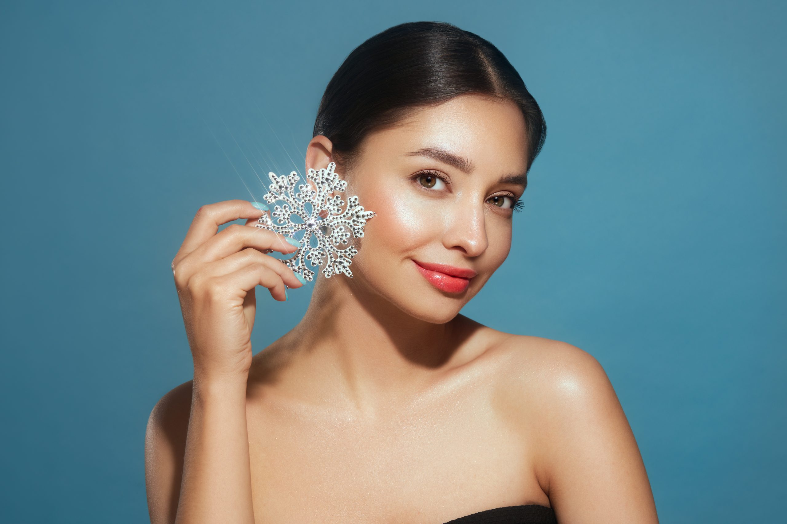 Beautiful young woman with glowing snowflake